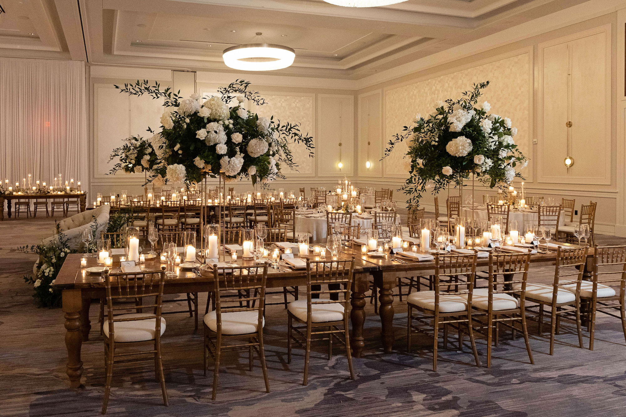 Elegant White Hydrangea and Rose Floral Arrangements with Ruscus Greenery | Candlelit Centerpieces | Tampa Bay Rental Company A Chair Affair | Florist Bruce Wayne Florals