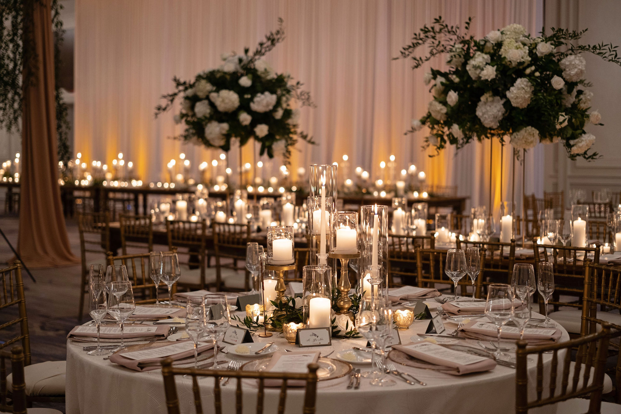 Elegant White Hydrangea and Rose Floral Arrangements with Ruscus Greenery | Candlelit Centerpieces | Tampa Bay Rental Company Gabro Event Services | A Chair Affair | Bruce Wayne Florals