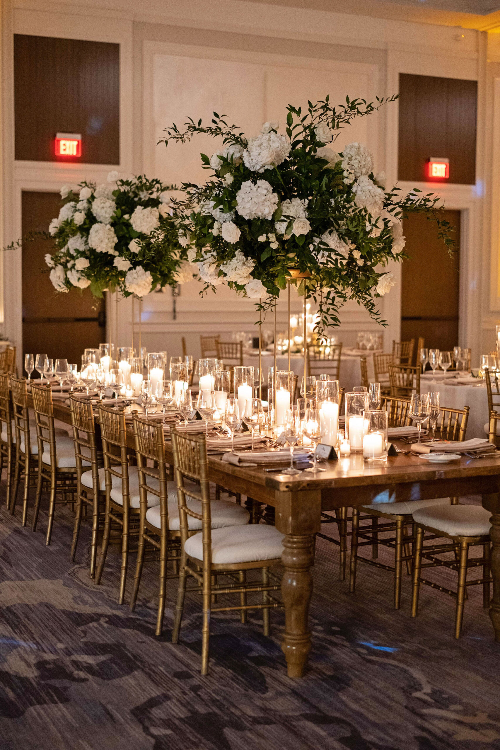 Elegant White Hydrangea and Rose Floral Arrangements with Ruscus Greenery | Long Feasting Table with Gold Chiaviari Chairs | Candlelit Centerpieces | Tampa Bay Rental Company Gabro Event Services | A Chair Affair | Bruce Wayne Florals