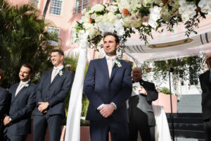 Groom's Reaction to Bride Walking Down Aisle | White Rose, Orchid, and Greenery Chuppah Wedding Ceremony Arch Inspiration