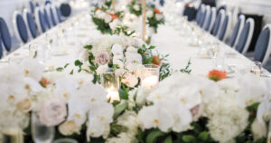 White Orchid and Orange Pin Cushion Protea Wedding Centerpiece Inspiration