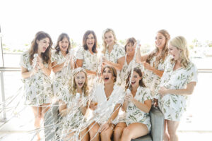 Bride Getting Ready with Bridesmaids Wedding Portrait | Matching Boho White and Greenery Pajamas Inspiration | St. Pete Beach Hair and Makeup Artist Femme Akoi Beauty Studio
