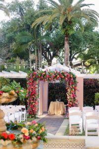 Pink Bougainvillea, Orange and Red Roses, Monstera Wedding Chuppah Floral Arrangement Inspiration