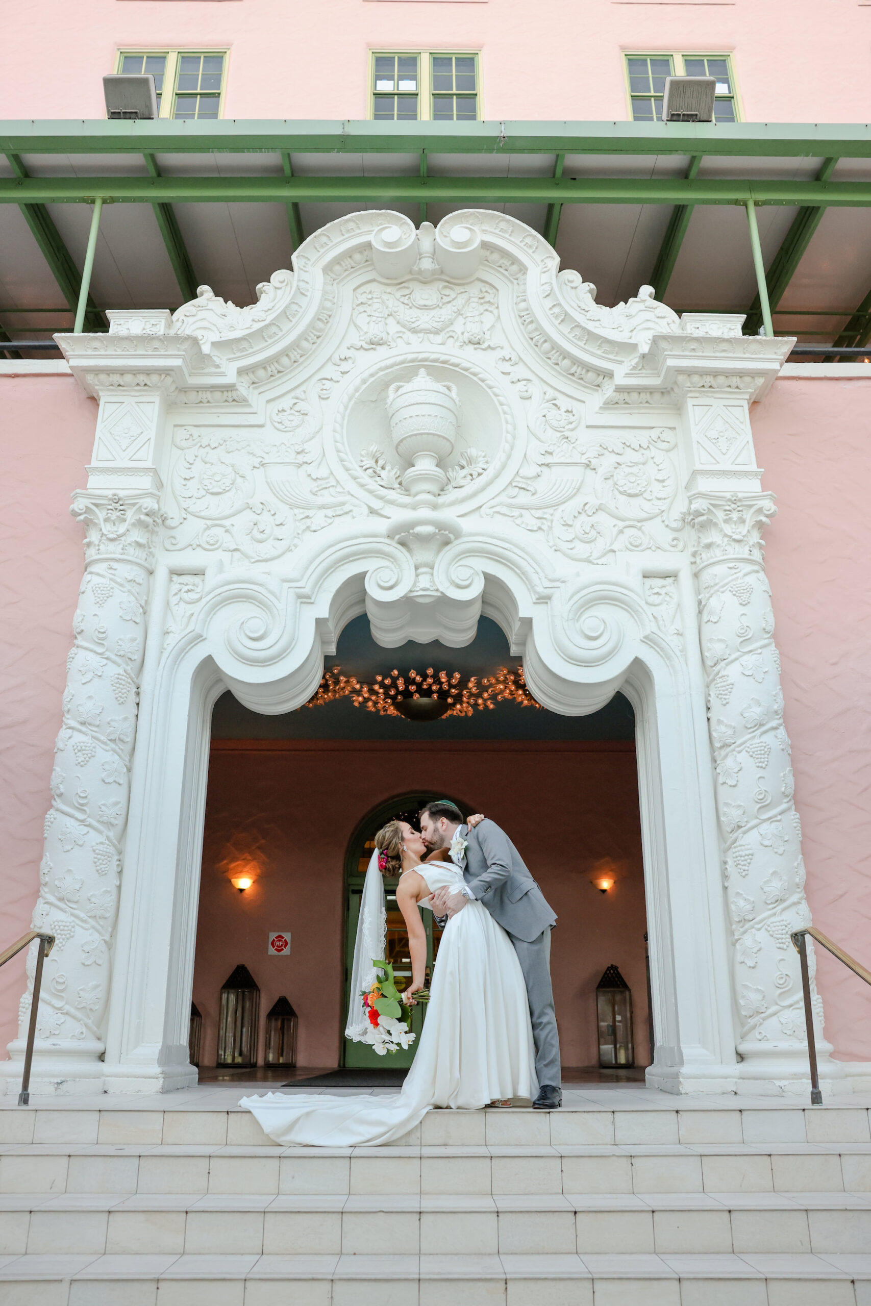 Bride and Groom Kiss on Front Steps | St Pete Wedding Venue The Vinoy