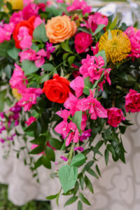 Bright Pink Bougainvillea, Red and Orange Roses, Yellow Pincushion Protea and Ruscus Greenery Wedding Flower Arrangements