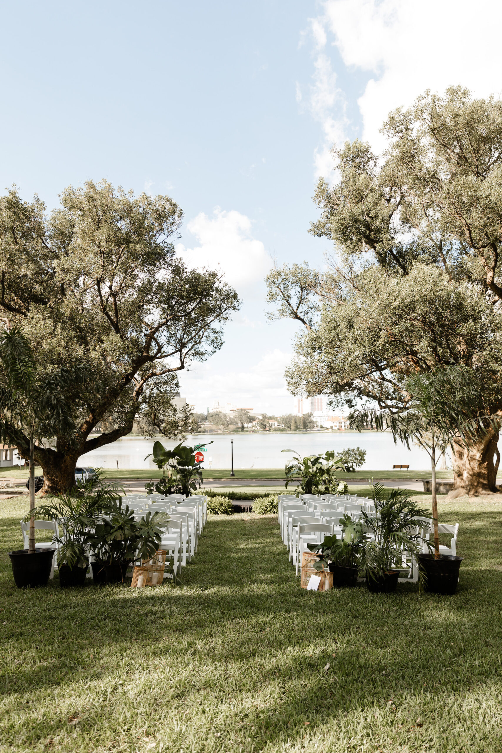 Lakeside Wedding Ceremony with White Garden Chairs | Lakeland Private Home
