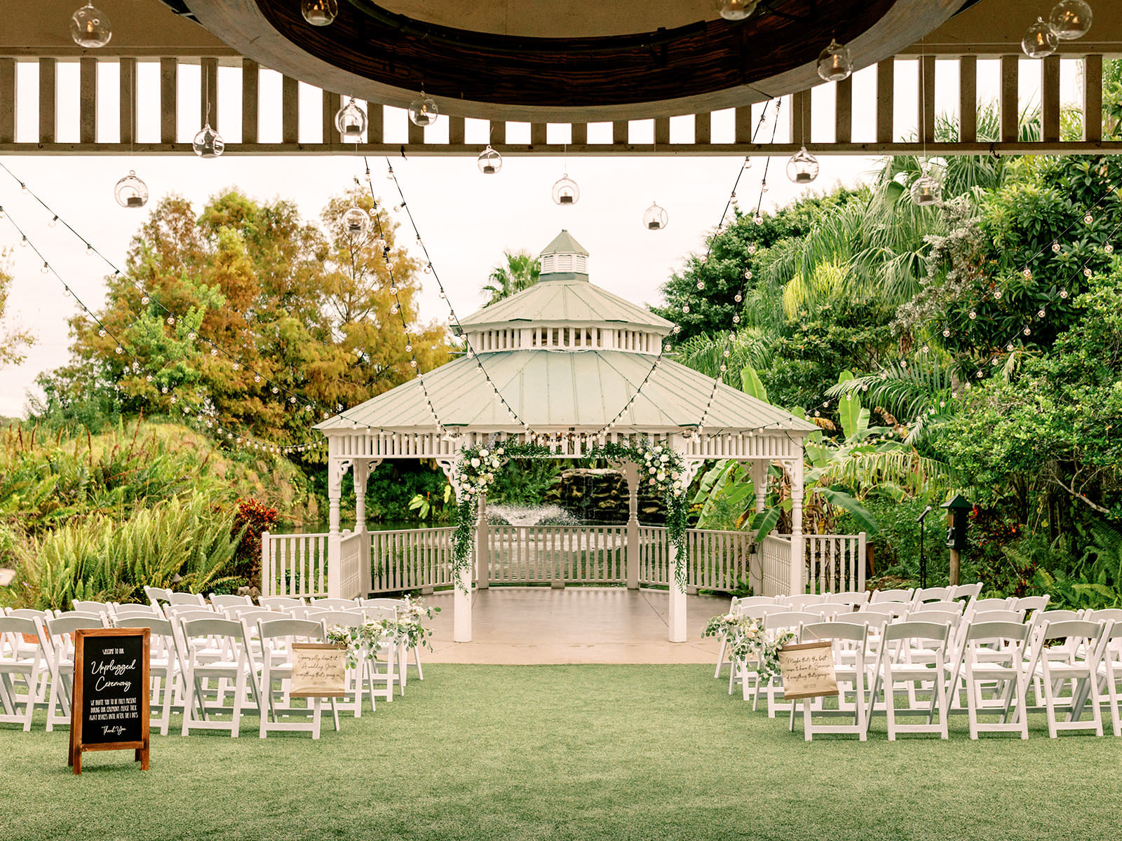 Outdoor Gazedo Wedding Ceremony | White Garden Chairs | Unplugged Ceremony A-Frame Sign