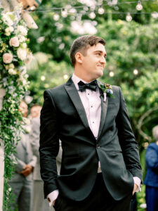 Groom's Reaction to Bride Walking Down Wedding Aisle | Black Tuxedo and Bowtie Groom Attire Ideas