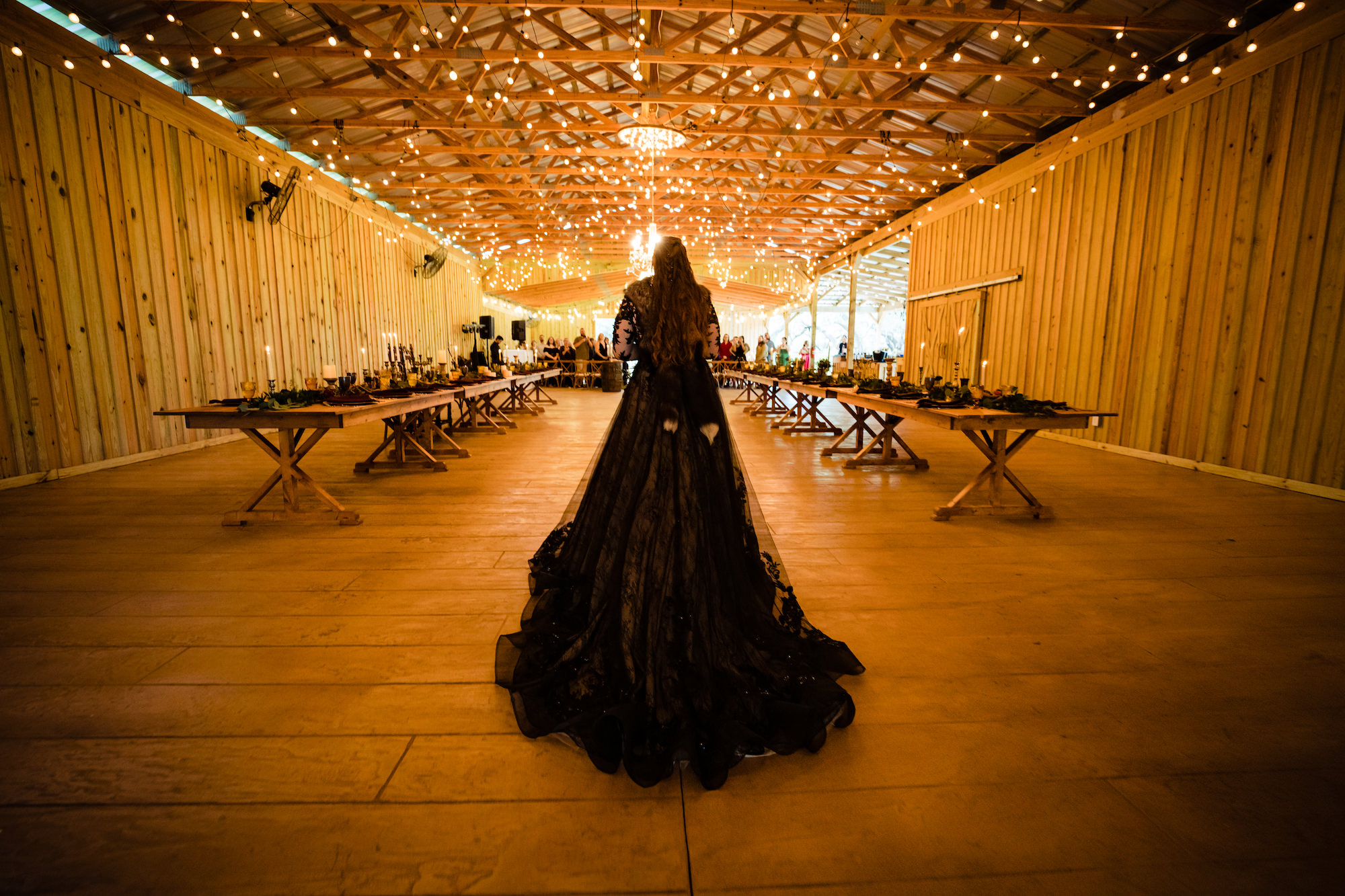 Bride Walking Down Ceremony Aisle in Black Dress | Dark and Moody Viking Themed Wedding Ideas