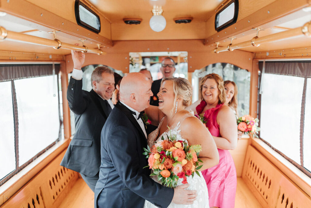 Bride and Groom on Trolley with Wedding Bridal Party