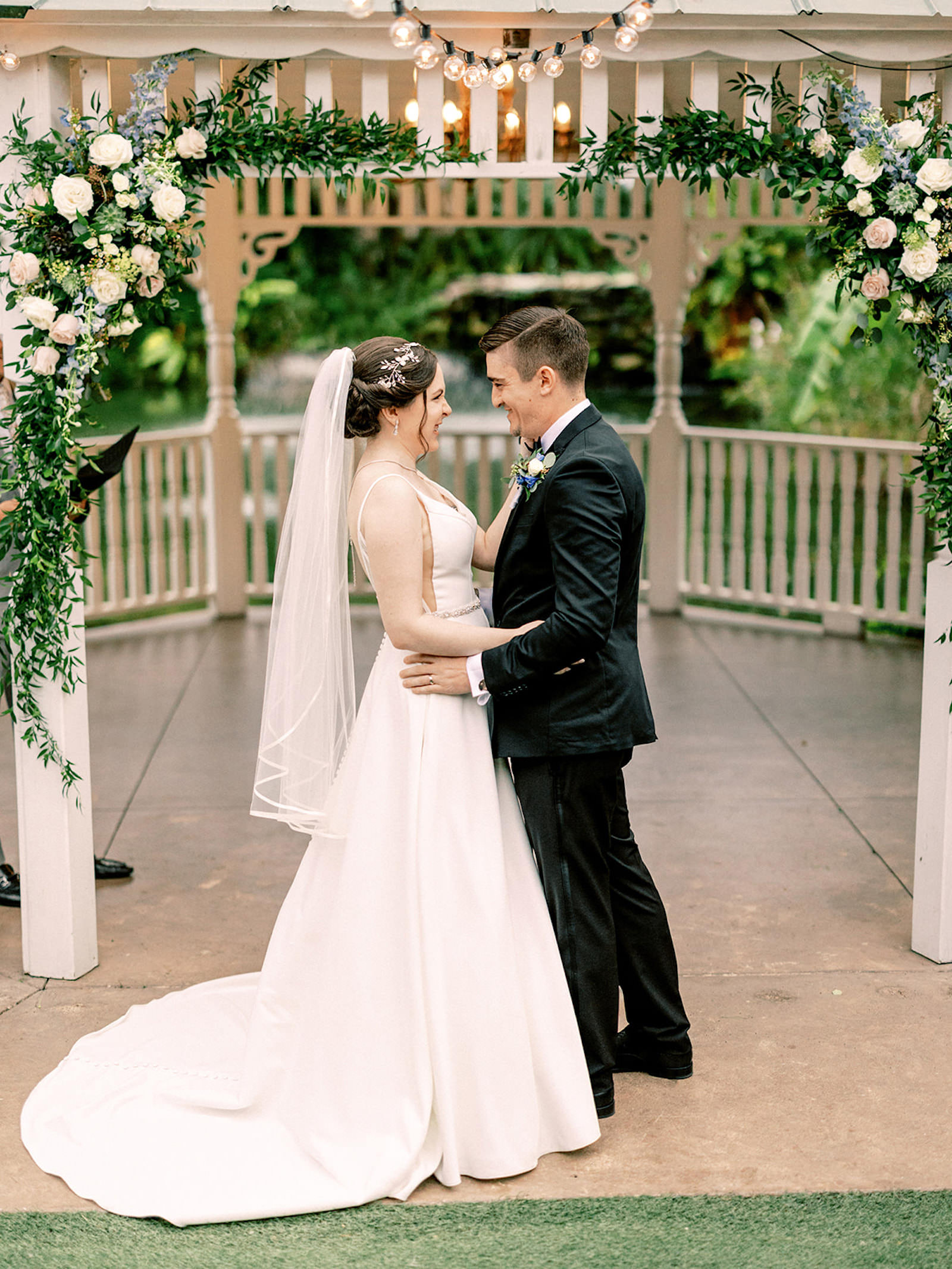 Intimate Bride and Groom Wedding Portrait | Gazebo Ceremony Ideas | Ruscus Greenery, Blue Snapdragon, Succulant, Pink and White Rose Flower Arrangement Altar Decor Ideas | Tampa Bay Videographer Shannon Kelly Films