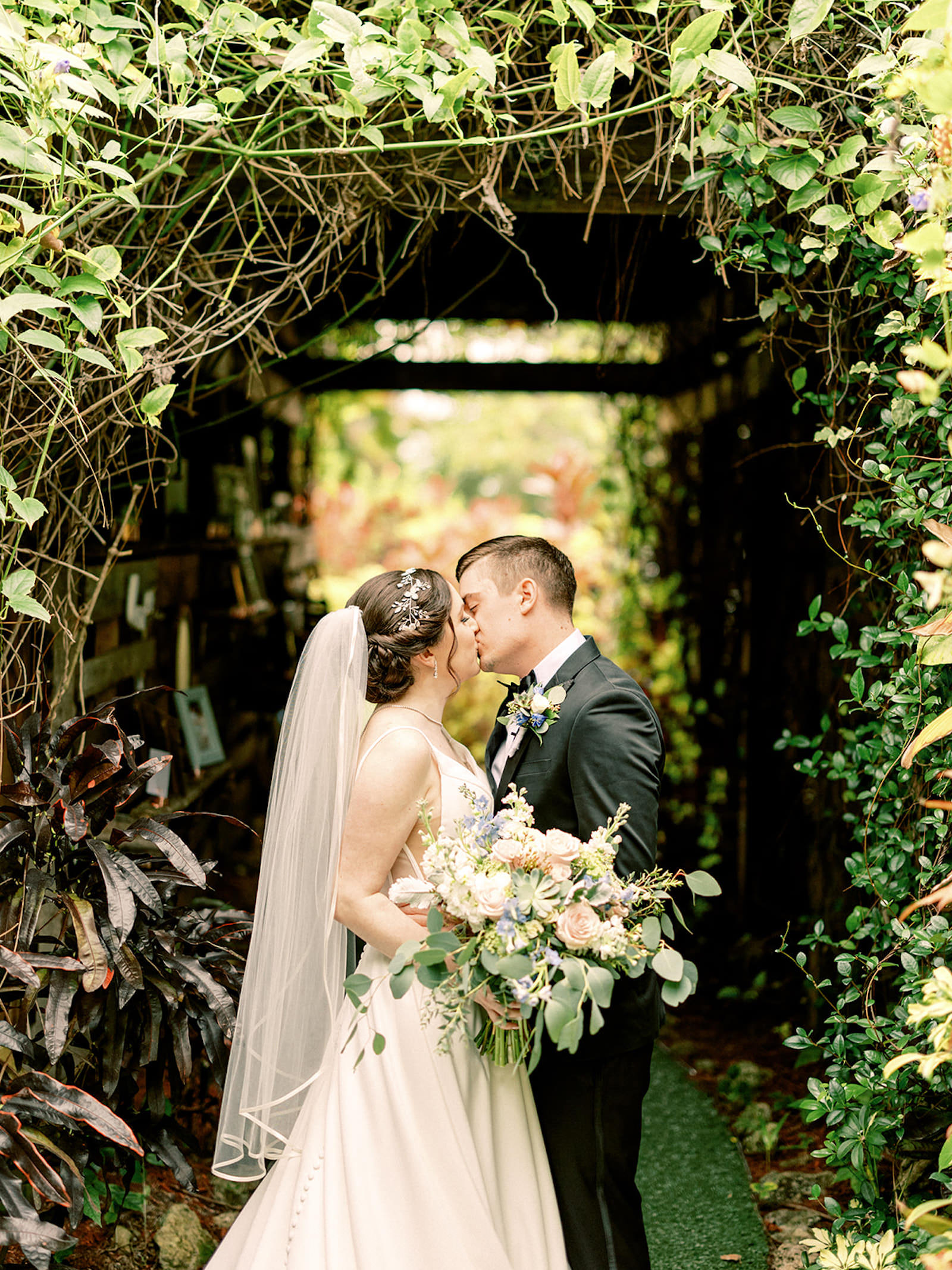 Bride and Groom in Vine Tunnel Romantic Wedding Portrait | Tampa Bay Videographer Shannon Kelly Films