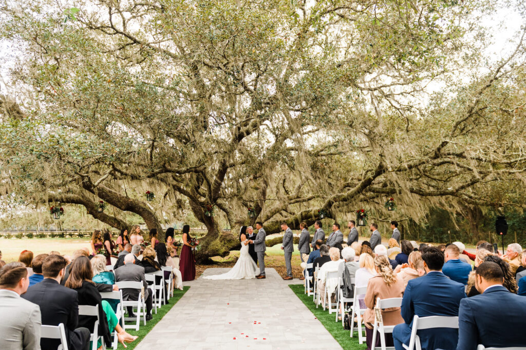 Bride and Groom Exchanging Vows | Grand Oak Tree Wedding Ceremony | Tampa Bay Venue Legacy Lane Weddings