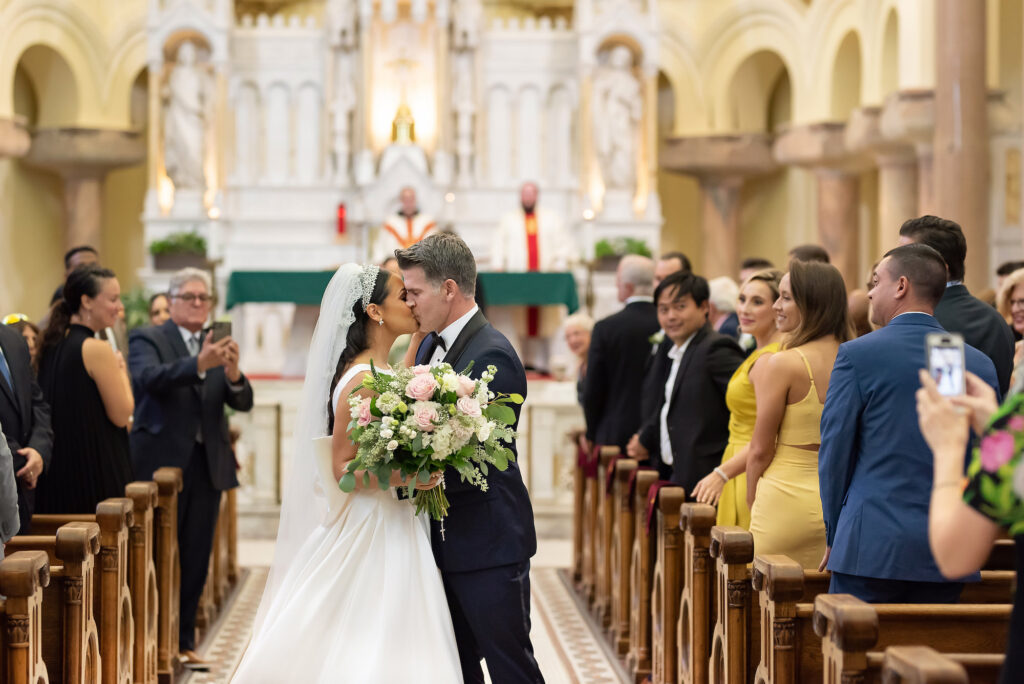 Bride and Groom Romantic Wedding Aisle Kiss | Tampa Bay Photographer Kristen Marie Photography | Venue Sacred Heart Catholic Church