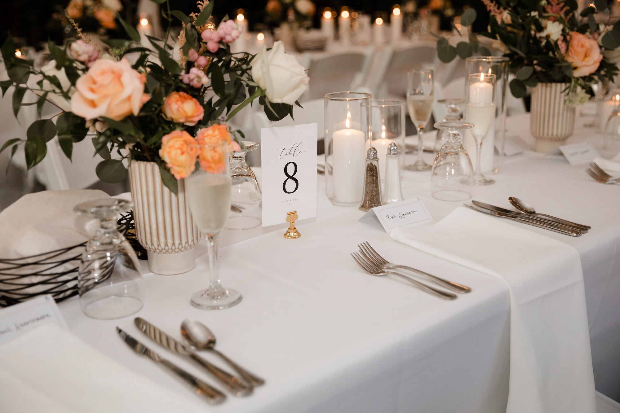 Orange and White Roses and Carnations with Ruscus and Eucalyptus Greenery Wedding Reception Centerpiece Ideas | Classic Table Number Signs