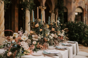 Wedding Tablescape with Florals and Greenery Garland Centerpieces, White Linen, Gray Napkins, and Cream Chargers | Reception Decor Ideas