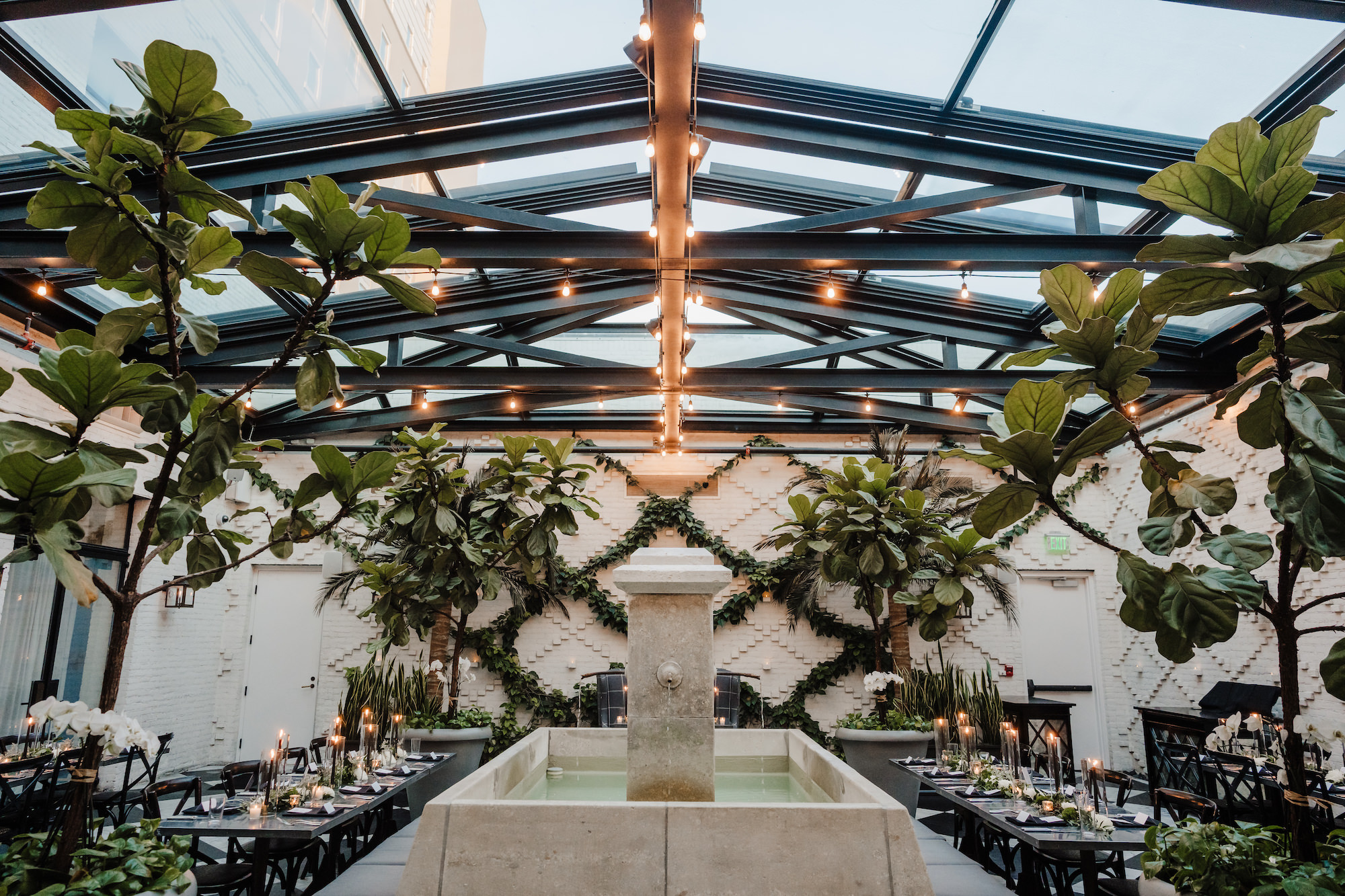 Timeless Industrial Indoor Wedding Reception with Black Crossback Chairs, Candles, and Greenery Tablescape Centerpiece Inspiration | South Tampa Wedding Planner Special Moments | Venue Oxford Exchange Conservatory
