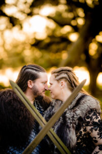 Bride and Groom Dark and Moody Viking Sword Wedding Portrait