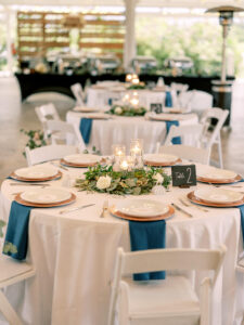 Peacock Blue Napkins with Gold Chargers | Eucalyptus and Floating Candle Centerpiece Ideas