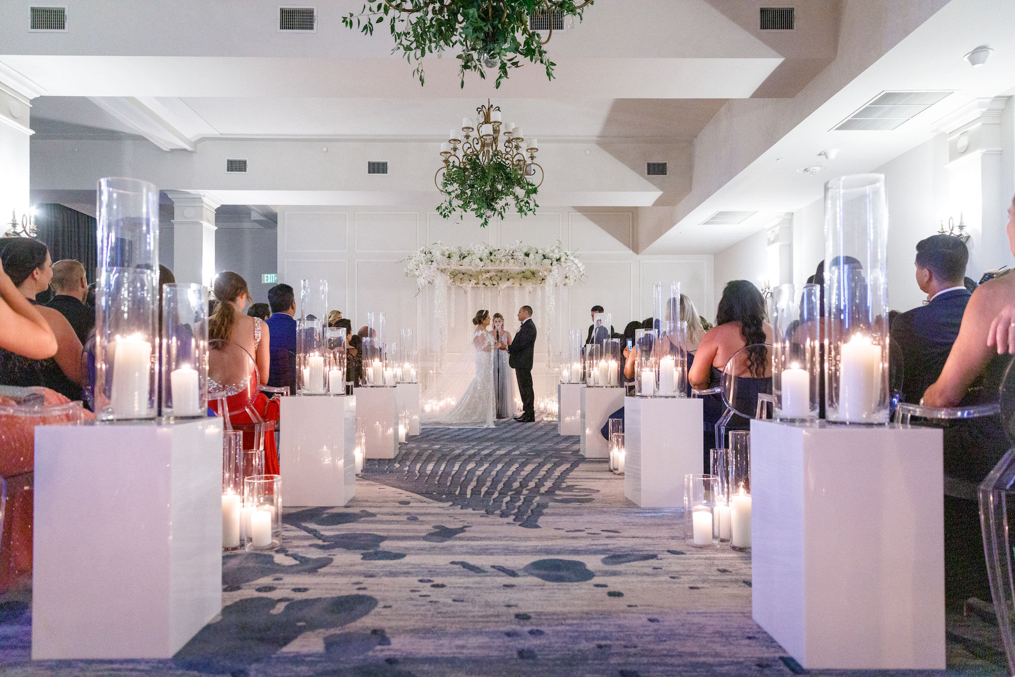 Modern Timeless Candlelit Wedding Aisle Ceremony Decor | White Pillar Candles | Ghost Acrylic Chairs Seating Inspiration | Buena Vista Ballroom Wedding Ceremony at St Pete Venue Don CeSar | St. Pete Florist FH Events