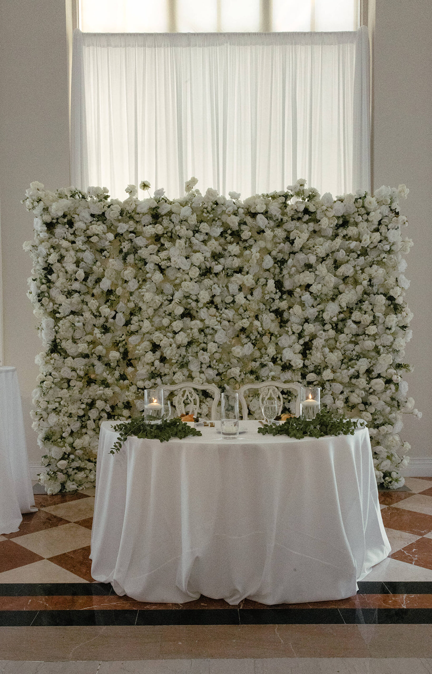 White and Greenery Flower Wall Backdrop for Sweetheart Table Inspiration | Modern Wedding Decor Ideas