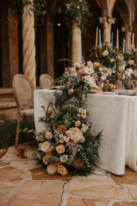 Wedding Tablescape with Luxurious Greenery Garland Floral Centerpiece with Muted Pastel Fall Colors