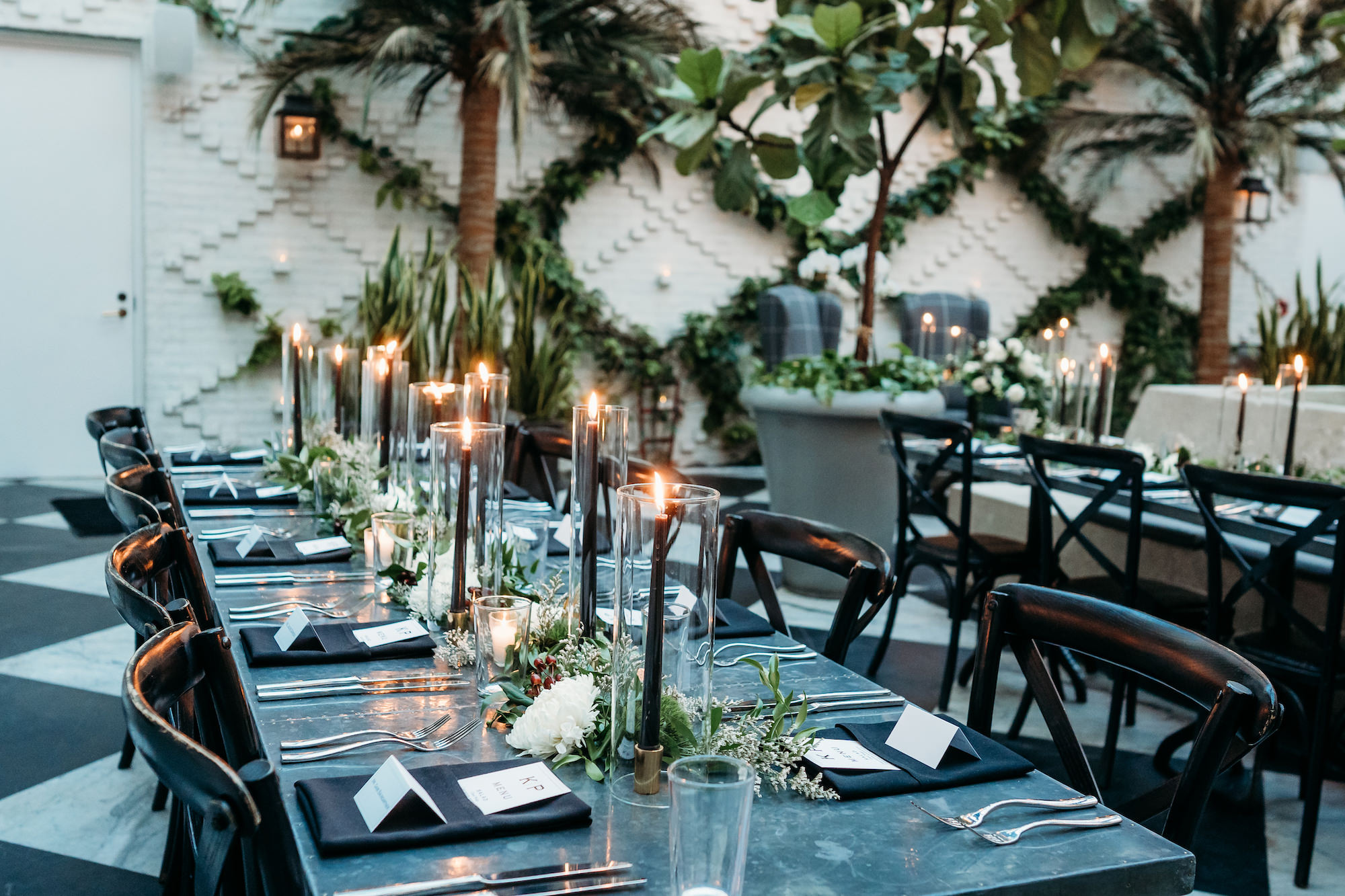 Modern Industrial Indoor Wedding Reception with Black Crossback Chairs, Candles, and Greenery Tablescape Centerpiece Inspiration | South Tampa Wedding Venue Oxford Exchange Conservatory
