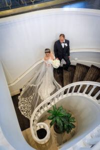 Bride and Groom on Stairs Wedding Portrait | St. Pete Beach Venue Don CeSar Hotel