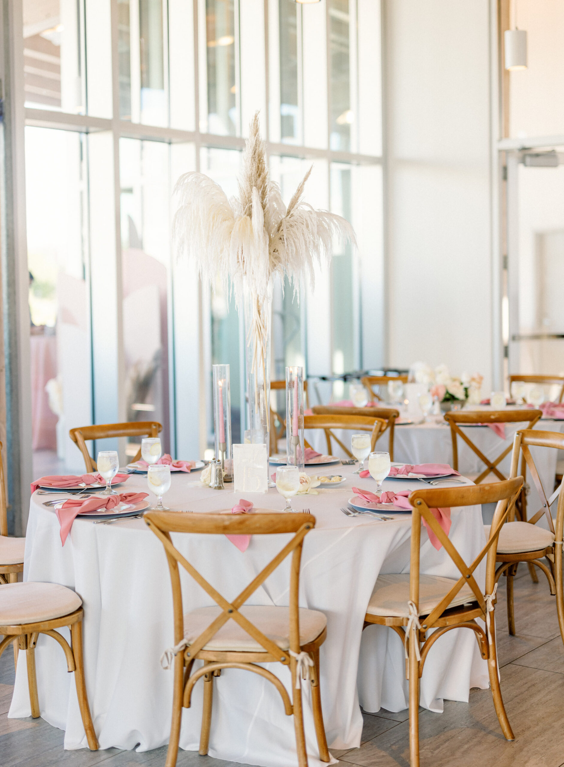 Pampas Grass Centerpiece Ideas | Wooden Crossback Chair Seating Inspiration | Pink Taper Candles with Hurricane Glass Tubes | Dusty Rose Boho Wedding Inspiration