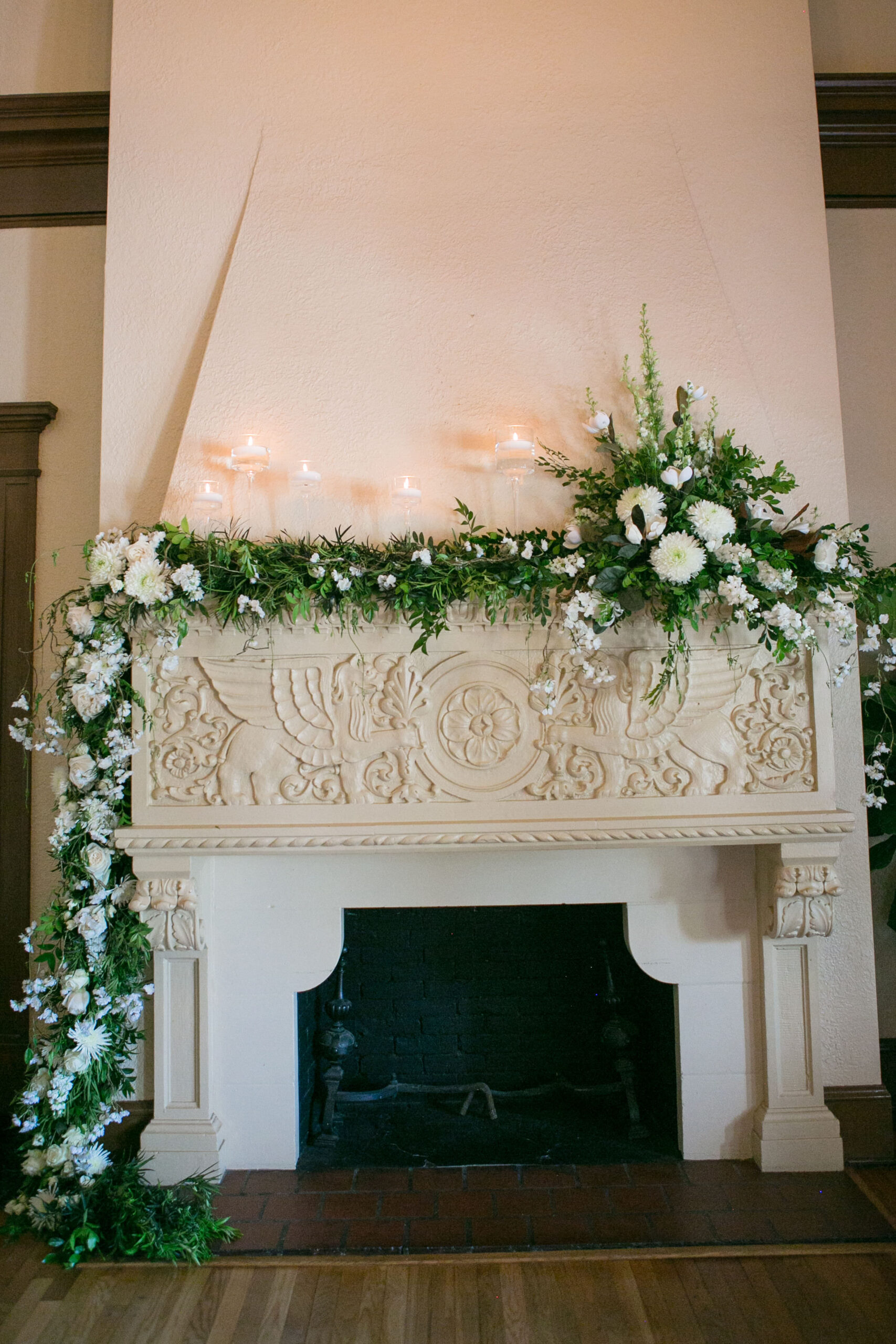 Cascading Fireplace Flower Arrangement Inspiration | White Crysanthemums, Roses, Snapdragons, Ferns, and Eucalyptus Greenery Altar Flower Arrangement Wedding Reception Decor