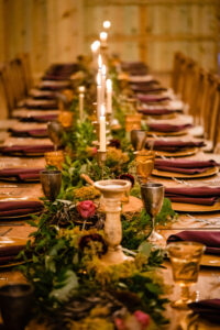 Vintage Candelabra | Greenery Centerpieces with Red Burgundy Napkins | Long Feasting Table | Dark and Moody Winter Wedding Reception Ideas