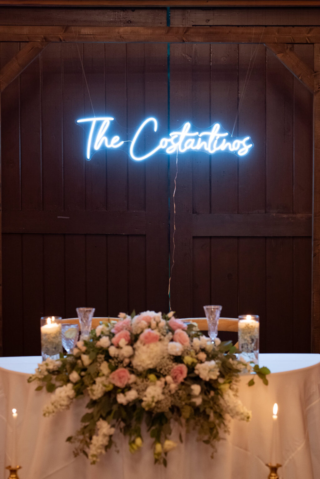 Custom Last Name Neon Sign | Table Top Floral Arrangement with White Hydrangeas, Stock Flowers, Pink Roses, Greenery Ideas | Sage Green and Blush Wedding Reception Inspiration