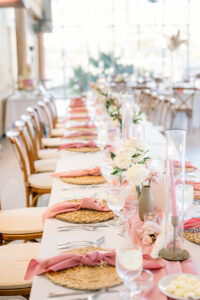 Hyacinth Placemats | Pink Taper Candles with Hurricane Glass Tubes | Dusty Rose Boho Wedding Inspiration | Tampa Bay Caterer Amici's Catered Cuisine