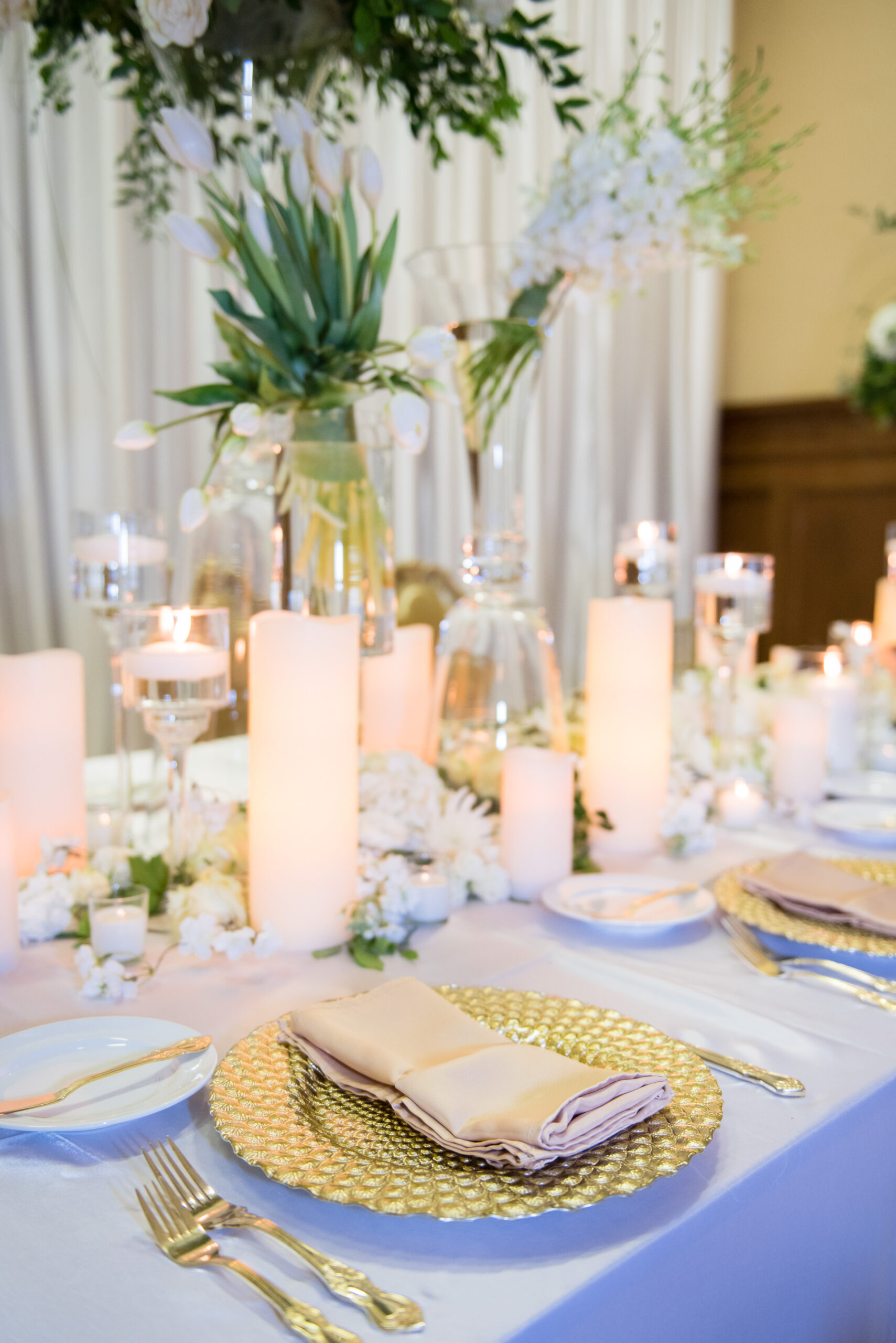 Pillar Candle and Floating Candle Centerpieces | Gold Chargers and Flatware | Elegant White and Gold Wedding Inspiration