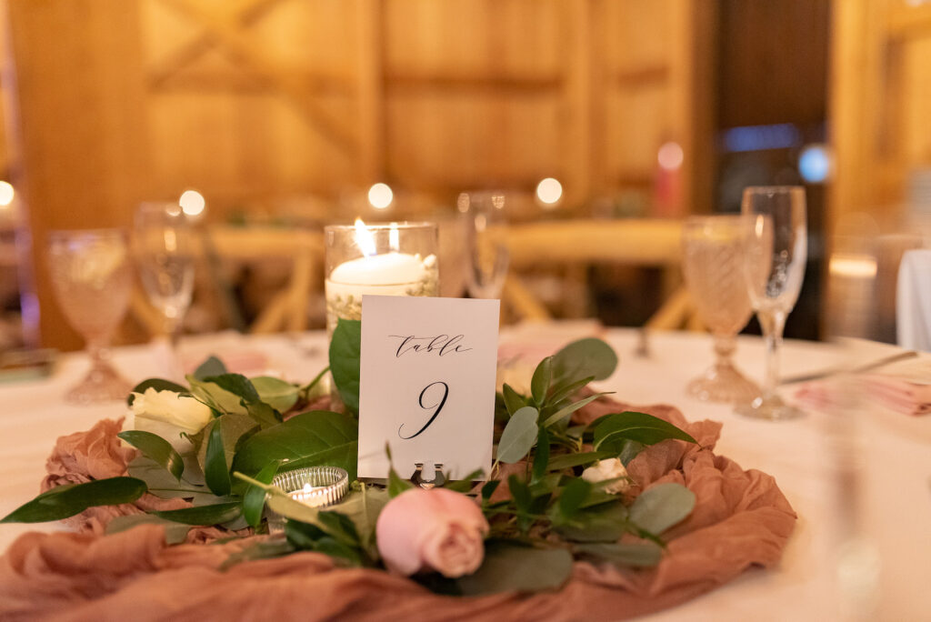 Tealight Candles | Greenery, White Baby's Breath, and Pink Roses Garland, Blush Cheese Cloth Table Runner Inspiration | Elegant Black and White Table Number Sign Reception Ideas | Tampa Bay Kate Ryan Rentals