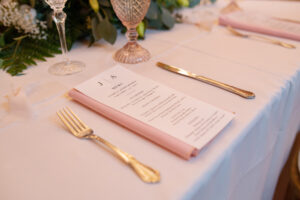 Simple Individual Menu Ideas | Blush Pink Goblets and Napkins, White Linens, and Gold Flatware | Sage Green and Blush Wedding Reception Inspiration | Tampa Bay Kate Ryan Rentals | Caterer Olympia Catering