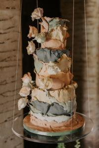 Whimsical Boho Three Tier Boho Wedding Cake with Layers in Blush and Blueish Garnished with Real Roses