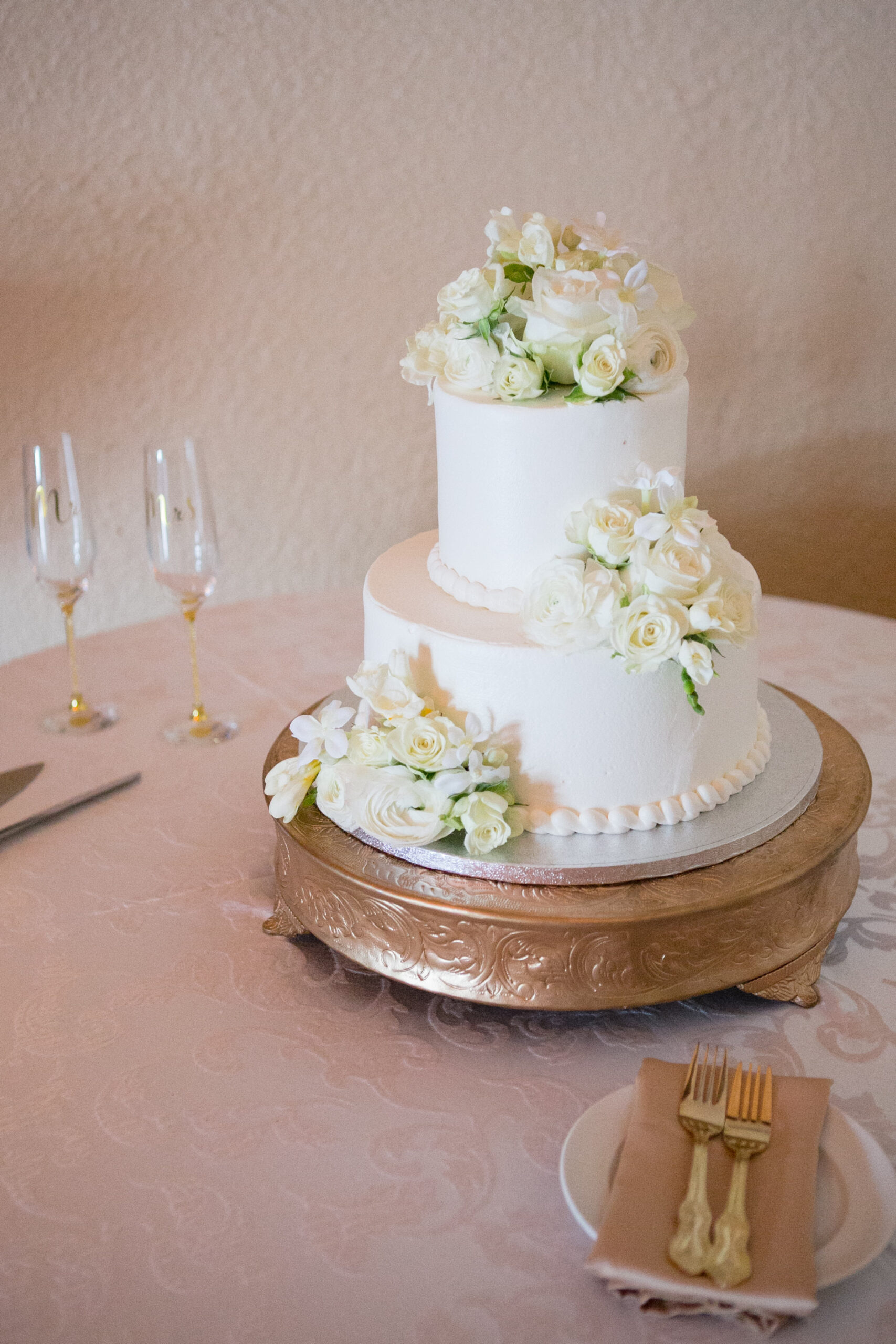 Two-tiered White Buttercream Wedding Cake with Baby Rose Arrangements