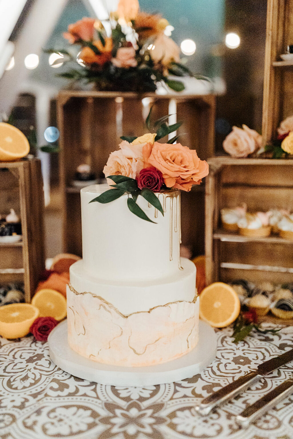 Rustic White and Ivory Two Tier Round Wedding Cake with Peach and Orange Floral Detailing and Citrus Accents Table Ideas | St Pete Cake Bakery The Artistic Whisk
