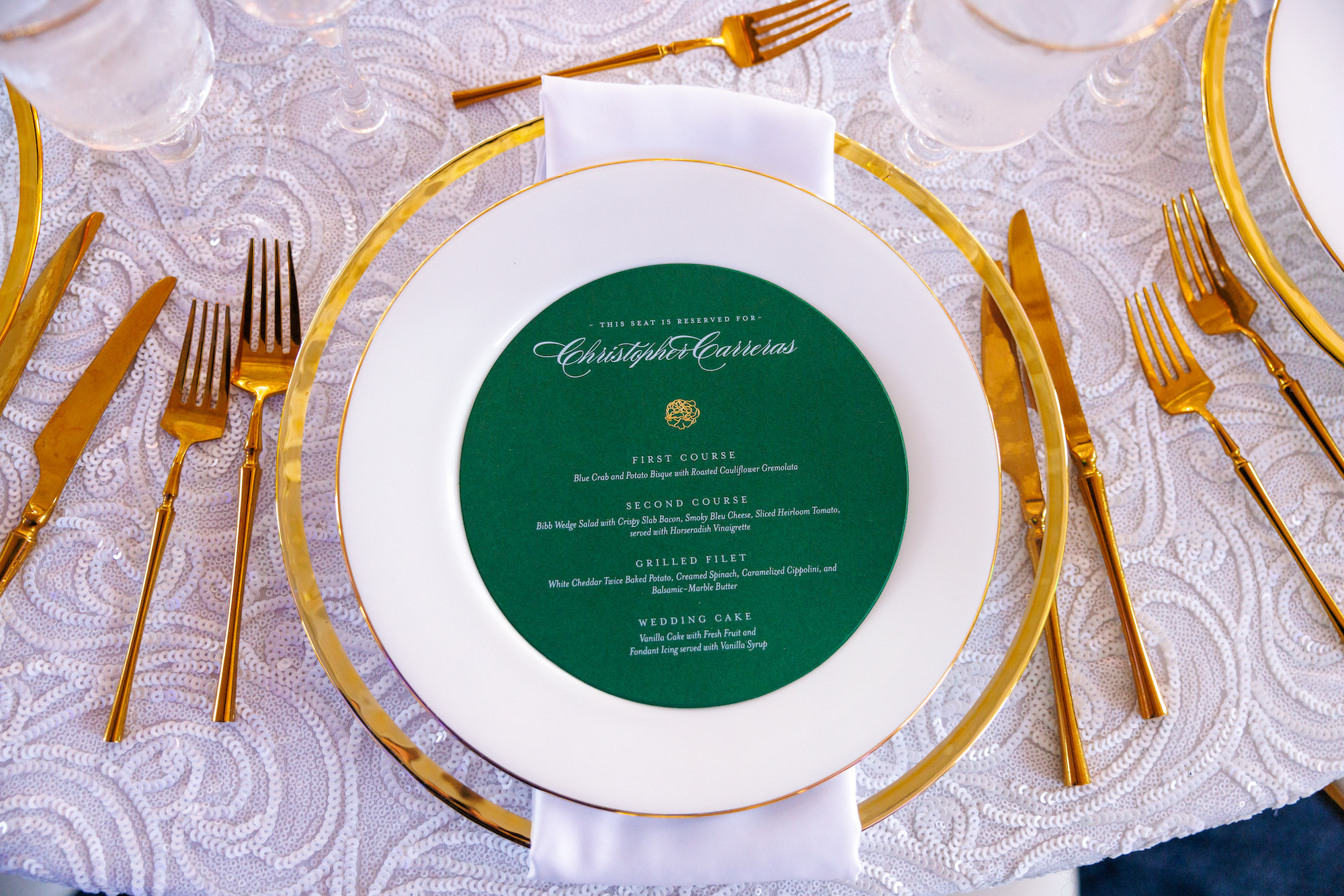 Gold Rimmed Chargers with Gold Flatware and White Sequin Linen Inspiration | Emerald Green Menu Card Ideas