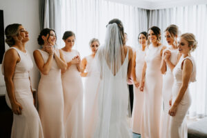 Bride and Bridesmaids First Look | Matching Blush Dress with Bateau Neckline and Cowl Back Inspiration