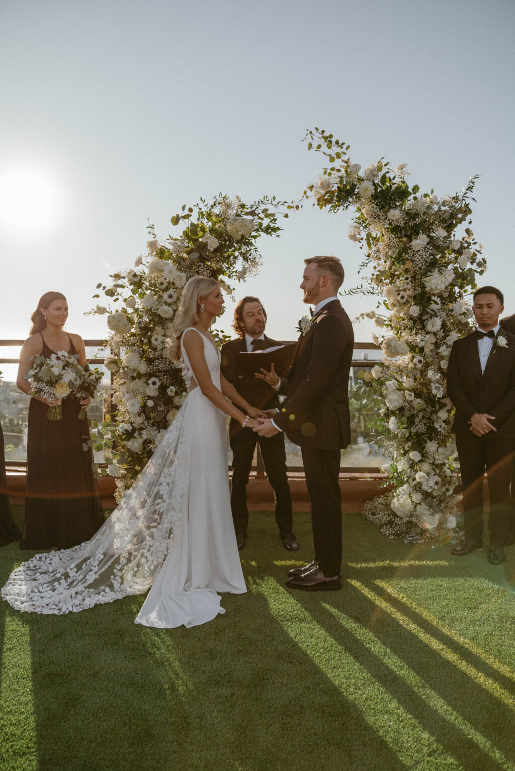 Bride and Groom Exchange Vows | Split Ceremony Arch White Floral and Greenery Ideas | St. Pete Beach Rooftop Venue Wedding Hotel Zamora | Florist Lemon Drops Wedding & Events