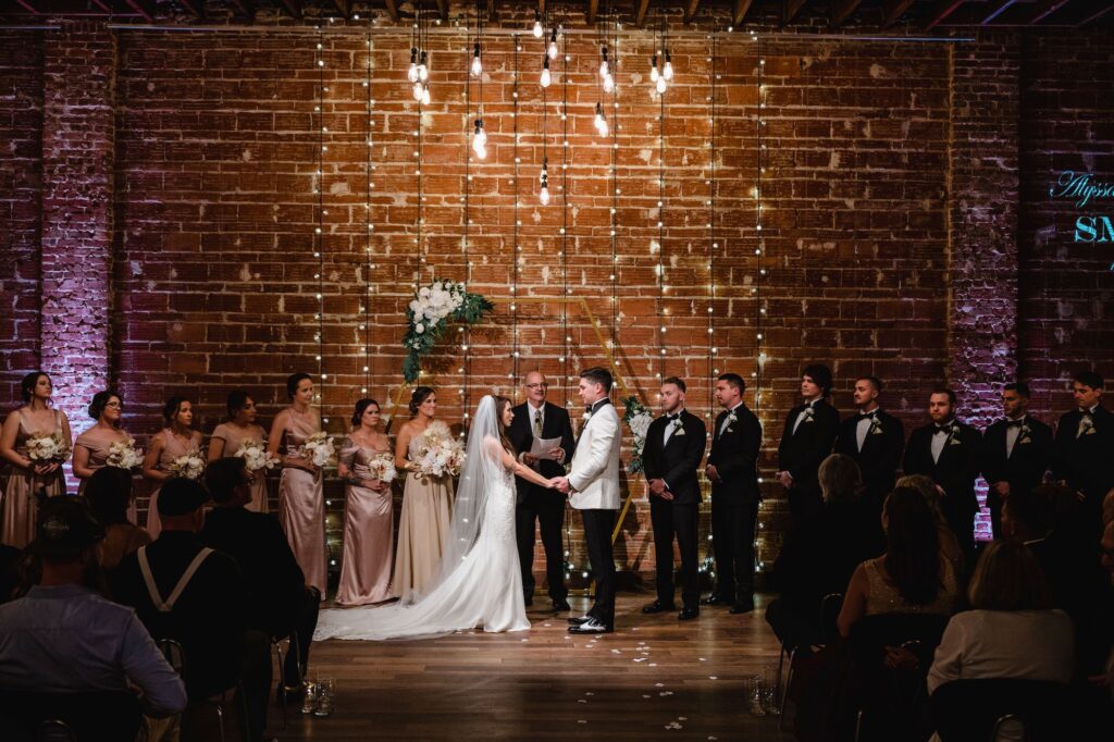 Bride and Groom Exchange Vows in Industrial Wedding Ceremony at St. Petersburg Venue NOVA 535
