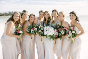Neutral Cream Mismatching Bridesmaids Dress Inspiration | Tropical White Orchid, Palm Leaf, Monstera, and Garden Rose Wedding Bouquet | Sarasota Florist Beneva Weddings and Events