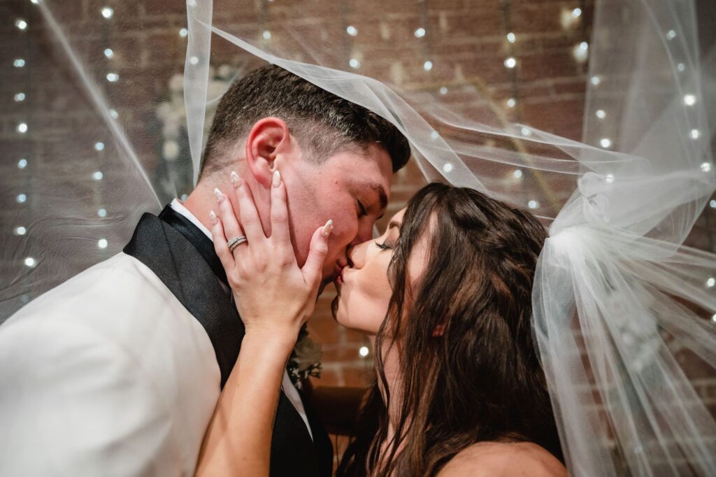 Bride and Groom First Kiss Under the Veil Wedding Portrait | St. Petersburg Wedding Photographer and Videographer Iyrus Weddings