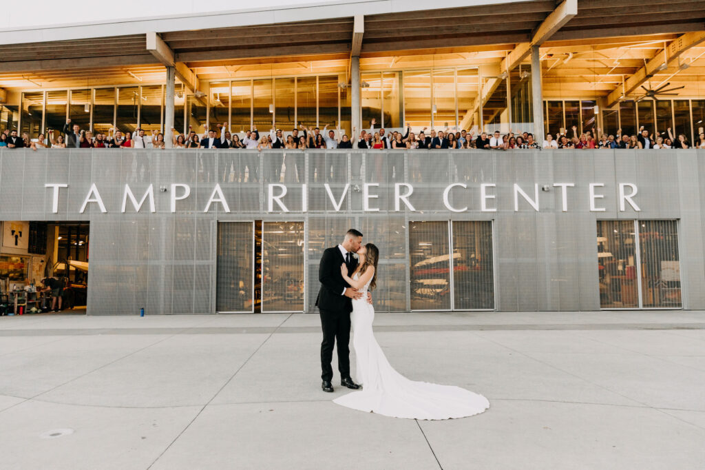 Bride and Groom in Front of Tampa River Center with Wedding Guests | Photographer Amber McWhorter Photography