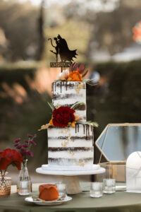 Naked Two-Tiered Wedding Cake with Orange and Maroon Rose Accents | Custom Batman and Cat Woman Laser Cut Wood Topper Ideas