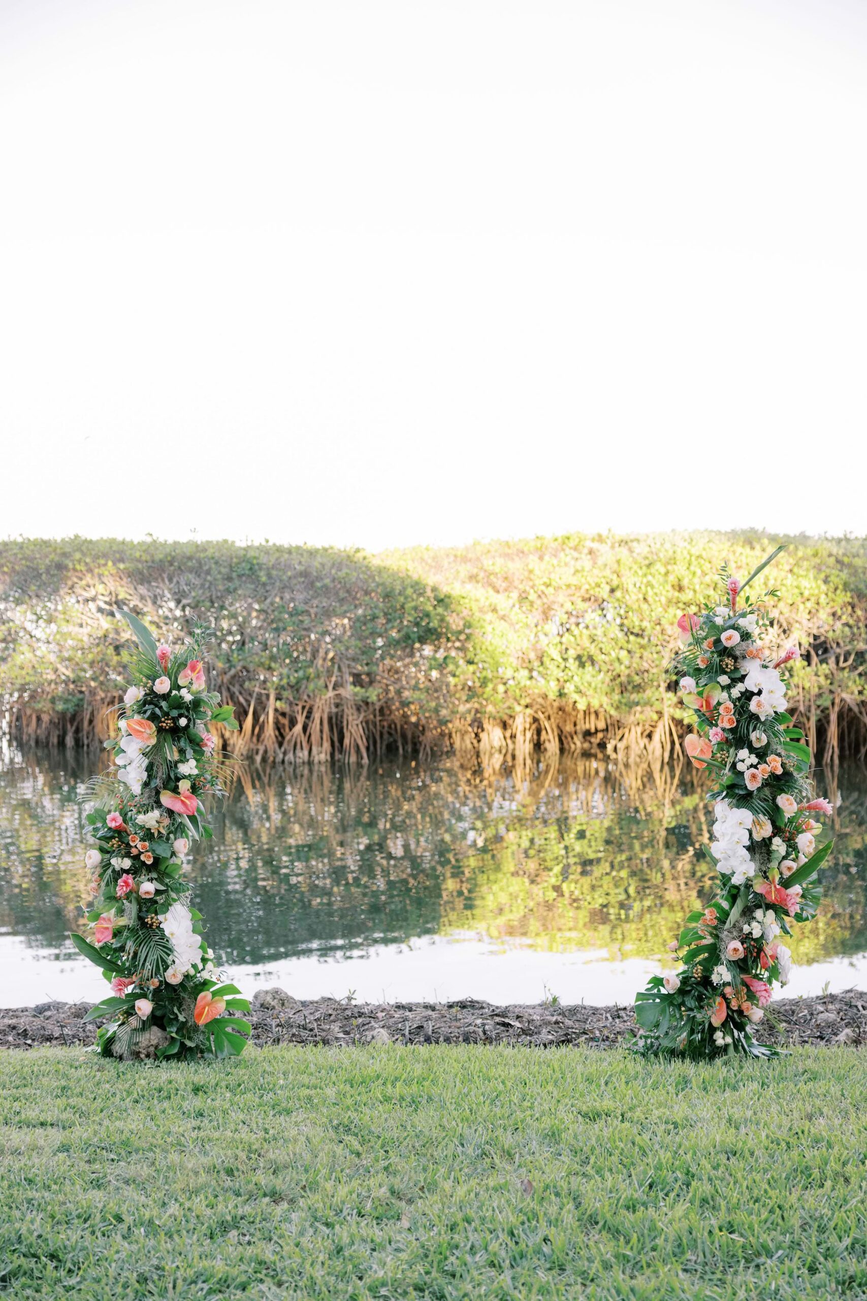 Waterfront Mangrove Asymmetrical Pink, Orange, and White Flower Stand Wedding Ceremony Altar Inspiration | Sarasota Florist Beneva Weddings and Events | Venue The Resort at Longboat Key Club