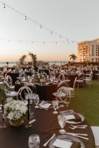 Elegant Rooftop Wedding Reception with Black Linen and Clear Acrylic Infiniti Ghost Chairs with Bistro Lighting Ideas | Rentals Outside the Box Rentals | St. Petersburg Hotel Wedding Hotel Zamora