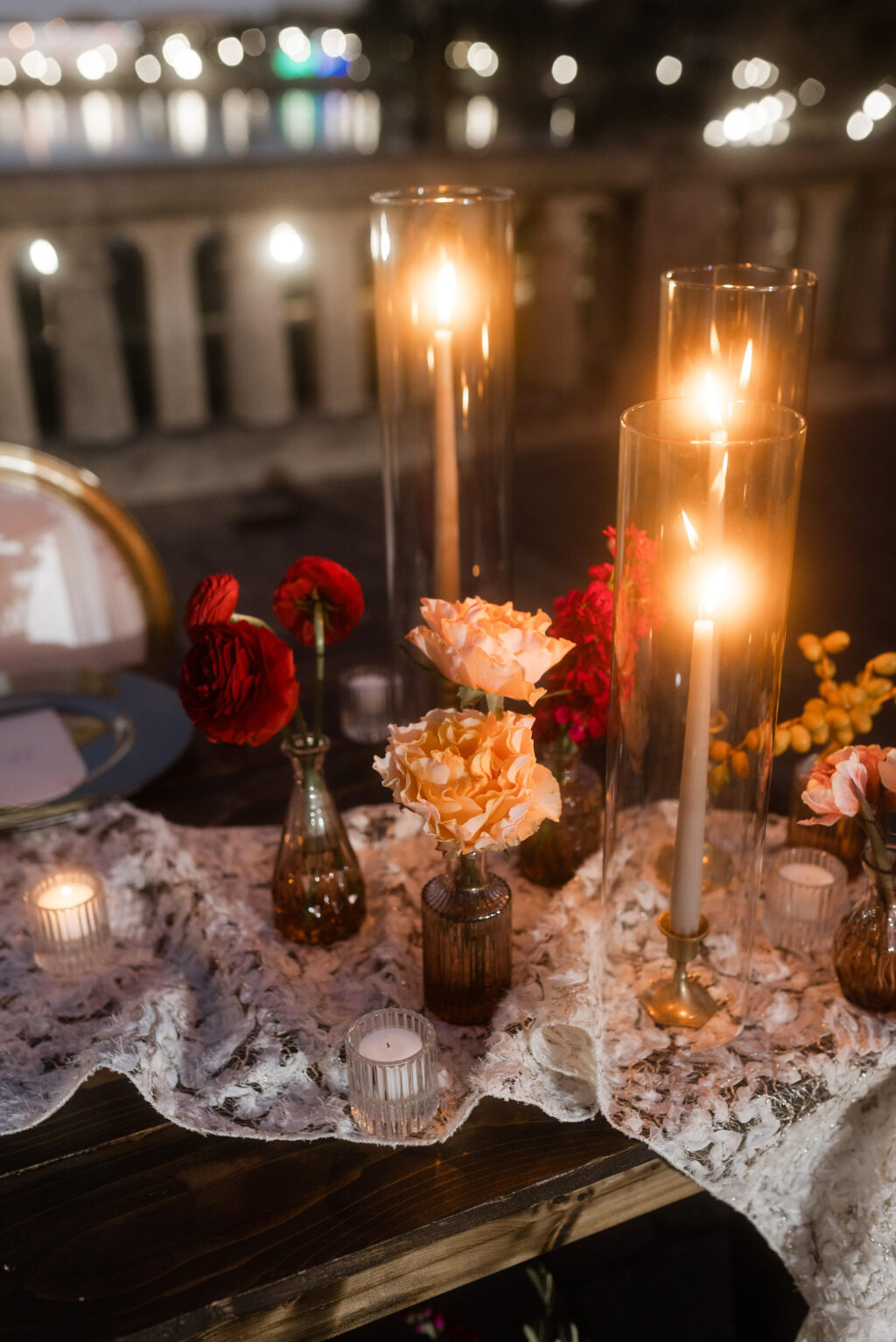 Lace Table Runner with Taper Candles and Hurricane Tube Glass | Maroon and Pink Garden Roses in Vintage Bud Vases | Moody Wedding Reception Inspiration